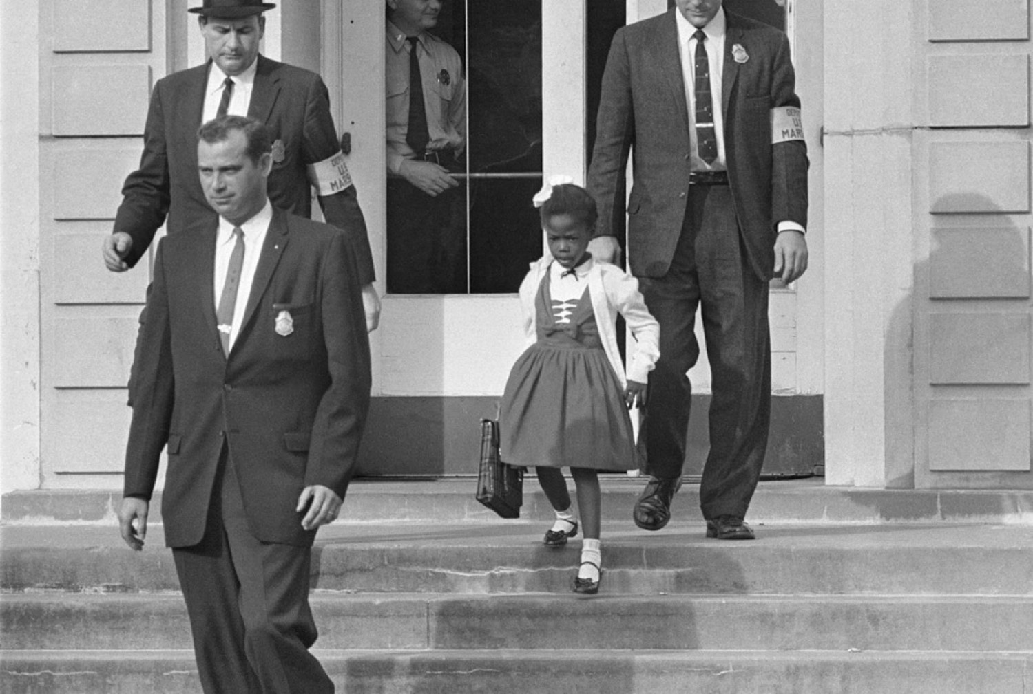 Ruby Bridges walking into a public school with U.S. marshals, New Orleans, 1960